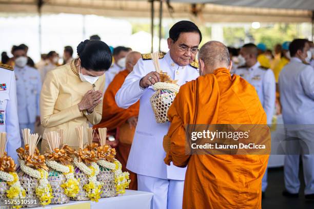 Caretaker Prime Minister, Prayut Chan-o-cha, takes part in a morning alms-giving ceremony to celebrate King Maha Vajiralongkorn's birthday on July...