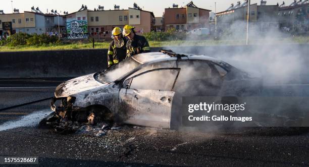 Burnt out car on the N2 near Langa on August 03, 2023 in Cape Town, South Africa. Commuters were left stranded after taxi operators went on strike...