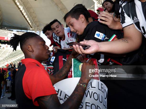 Rafael Leao of AC Milan signs an autograph for a fan before the Pre-Season Friendly match between Juventus and AC Milan at Dignity Health Sports Park...