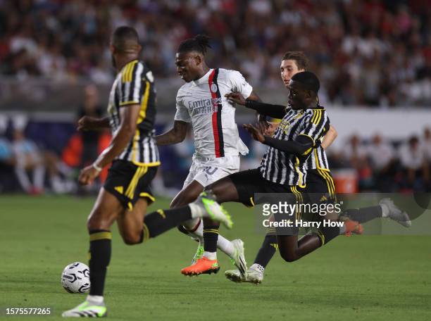 Rafael Leao of AC Milan attacks with the ball between Gleison Bremer, Fabio Miretti and Timothy Weah of Juvetus during the Pre-Season Friendly match...