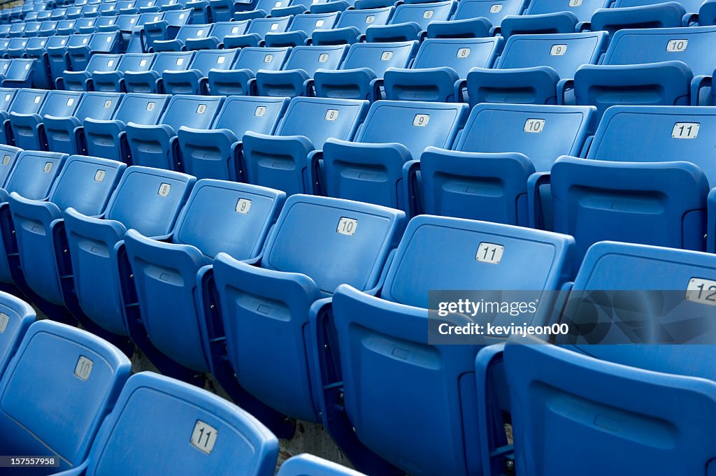 An empty blue arena seats with numbers