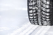 A tire leaving tracks in the snow