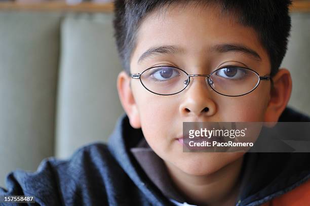 boy with glasses looking at the camera - kid sitting stock pictures, royalty-free photos & images