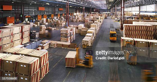 view from above inside a busy huge industrial warehouse - freight transportation stock pictures, royalty-free photos & images