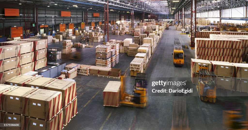 View from above inside a busy huge industrial warehouse