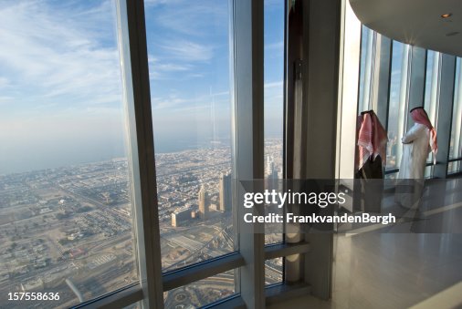 Two Arab men looking over Dubai from the Burj Khalifa Two Arab men looking over Dubai from the Burj Khalifa