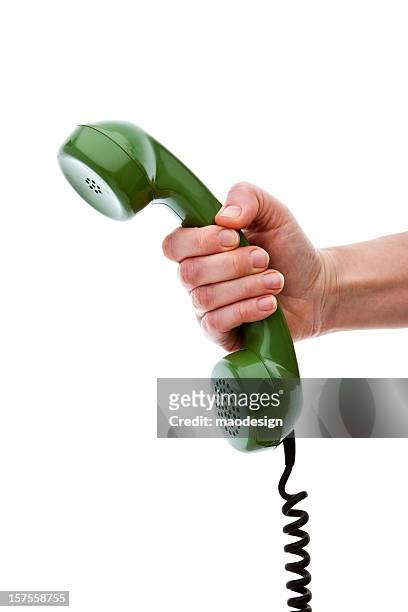hand holding green phone receiver, isolated - telefonlur bildbanksfoton och bilder