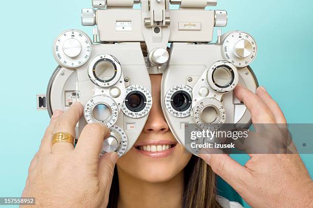 optometrist eye exam phoroptor - phoropter stock pictures, royalty-free photos & images