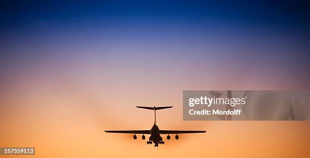 jet airplane landing in beautiful sunset sky - airplane engine stock pictures, royalty-free photos & images