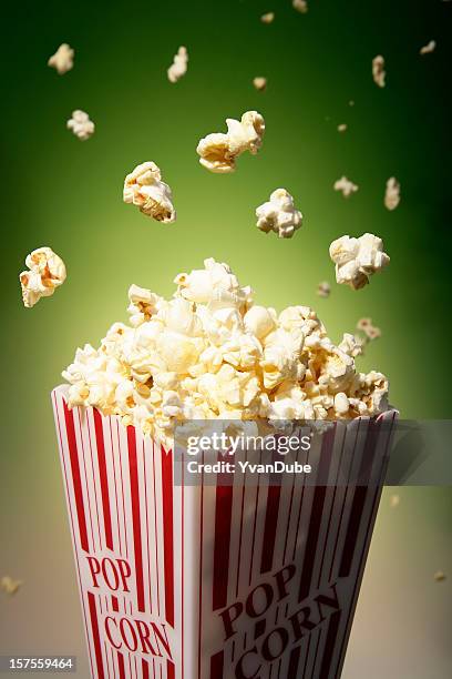 popcorn and flying popcorn in a box used in movie theaters - movie explosion stockfoto's en -beelden