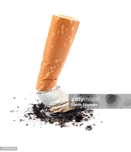 extinguished cigarette butt isolated on white background - cigarette stock pictures, royalty-free photos & images