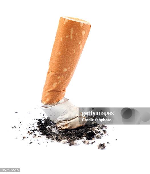 extinguished cigarette butt isolated on white background - stubbing out cigarette stock pictures, royalty-free photos & images