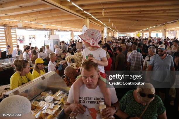 Visitors choose chese while visiting the "Cheese. Feast. World" festival on August 4, 2023 in Istra, 56 km west of Moscow, Russia. 350 food companies...