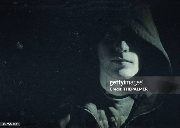 mysterious man hidden under a hooded shirt - suspicion stock pictures, royalty-free photos & images