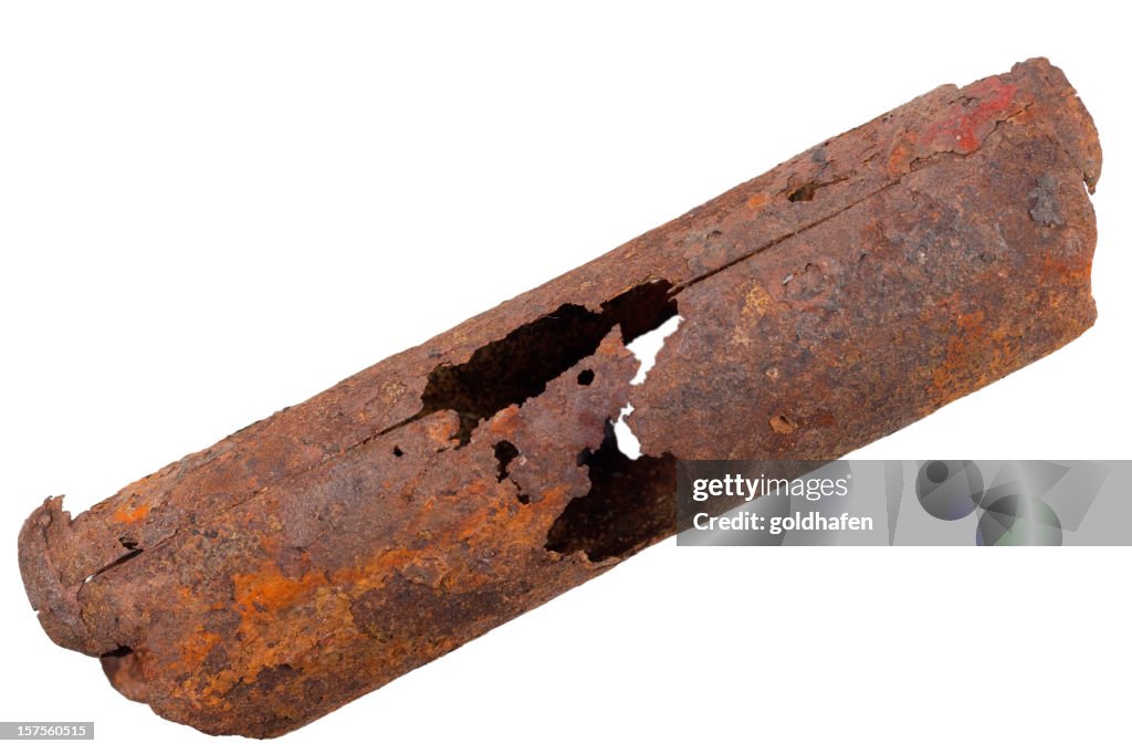 Old rusty pipe with hole in the middle 