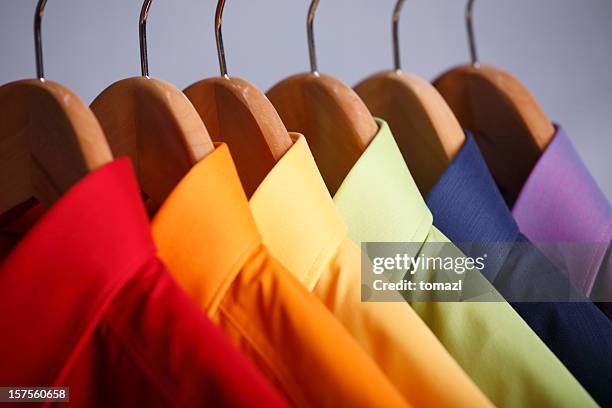 close-up of rainbow shirt collars hanging in closet - fashion orange colour stock pictures, royalty-free photos & images