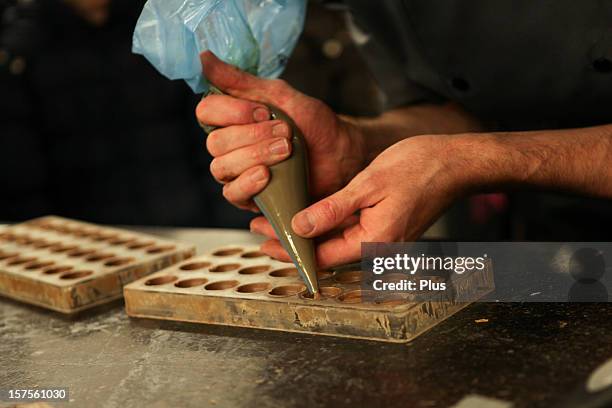 artisanal production of belgian chocolates - belgian culture stock pictures, royalty-free photos & images