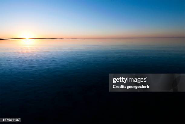 sunset over calm water - monkey mia stock pictures, royalty-free photos & images