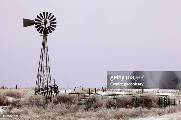 windmill, grassland, purple sunrise - kansas nature stock pictures, royalty-free photos & images