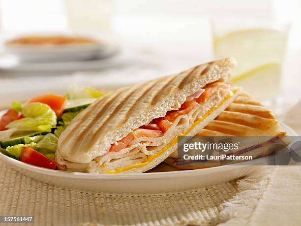 grilled turkey, cheese and tomato panini - panini stock pictures, royalty-free photos & images