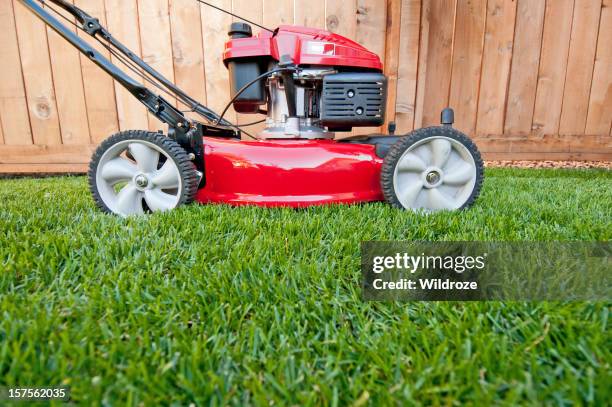 bright red lawn mower ready for business - grass clippings stock pictures, royalty-free photos & images