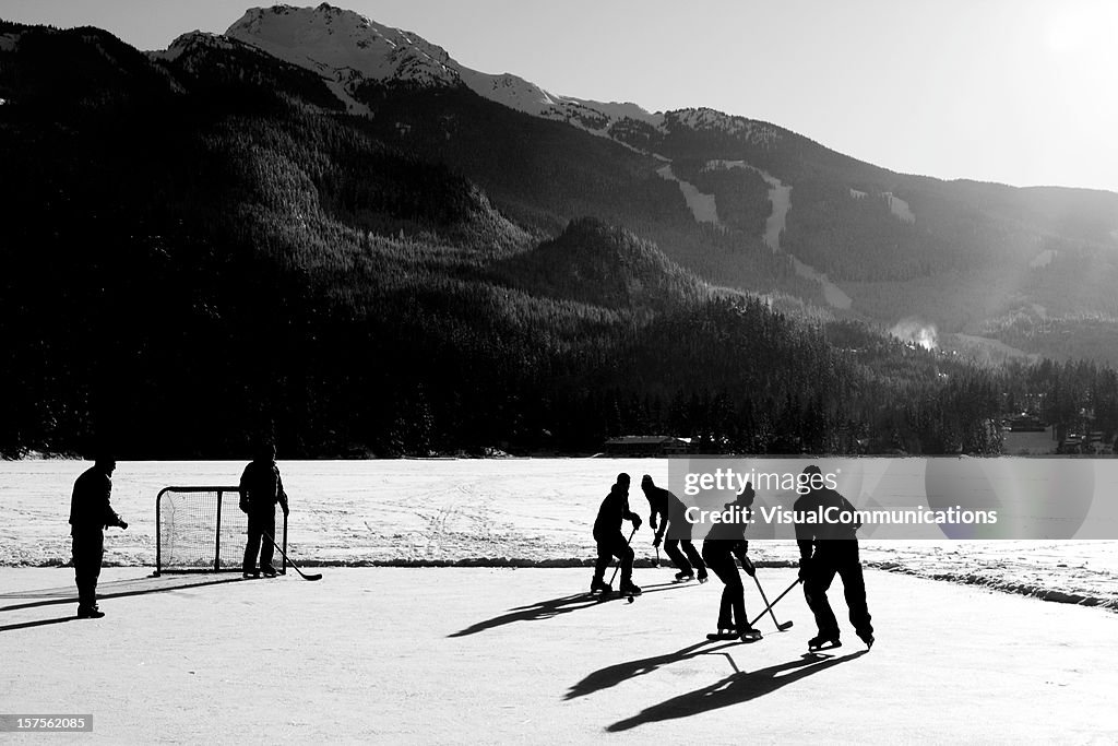 Hockey game on frozen lake.