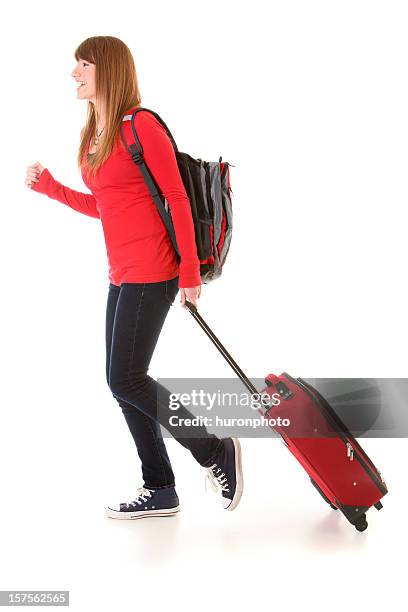 young woman walking with suitcase - woman walking studio back stock pictures, royalty-free photos & images