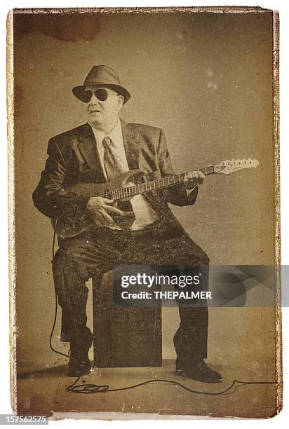 elegant senior playing an electric guitar - vintage electric guitar stock pictures, royalty-free photos & images