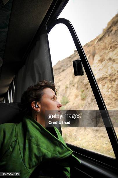 young woman looks out bus window - greyhound bus interior stock pictures, royalty-free photos & images