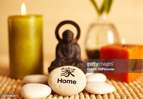 spa still life buddha statue and candles, home pebble - feng shui house stock pictures, royalty-free photos & images