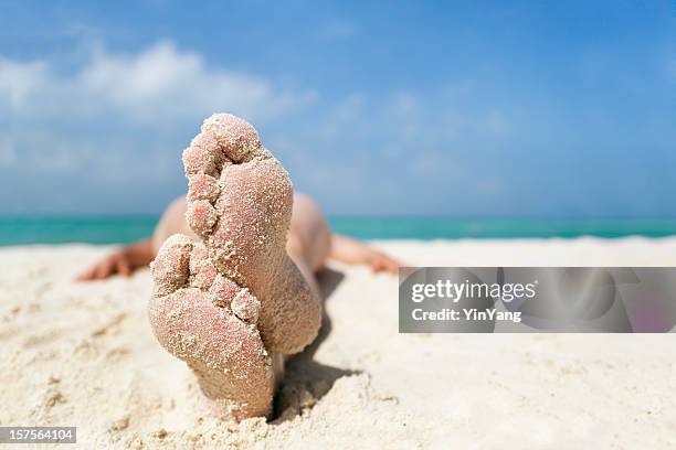 woman’s feet relaxing, sunbathing on beach sand vacation, cancun, mexico - playa del carmen stock pictures, royalty-free photos & images