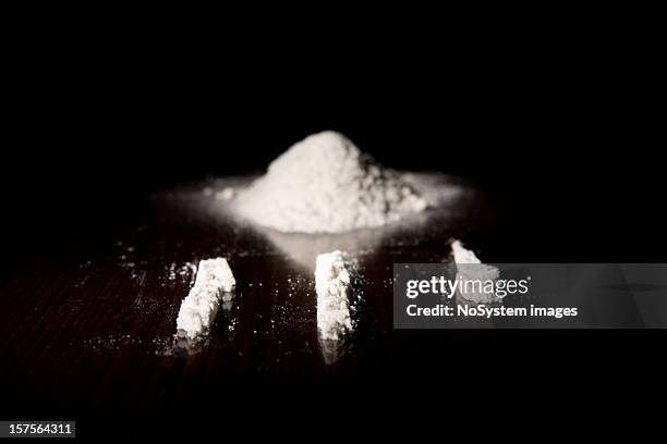 three lines of cocaine next to a pile of it - cuoca stock pictures, royalty-free photos & images