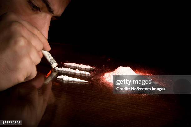 man sniffing three lines of cocaine - snorting stock pictures, royalty-free photos & images