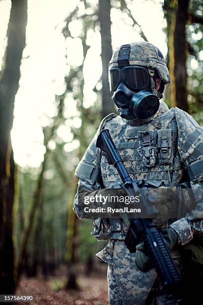 modern soldier in dark woods with gun - respirator mask stock pictures, royalty-free photos & images
