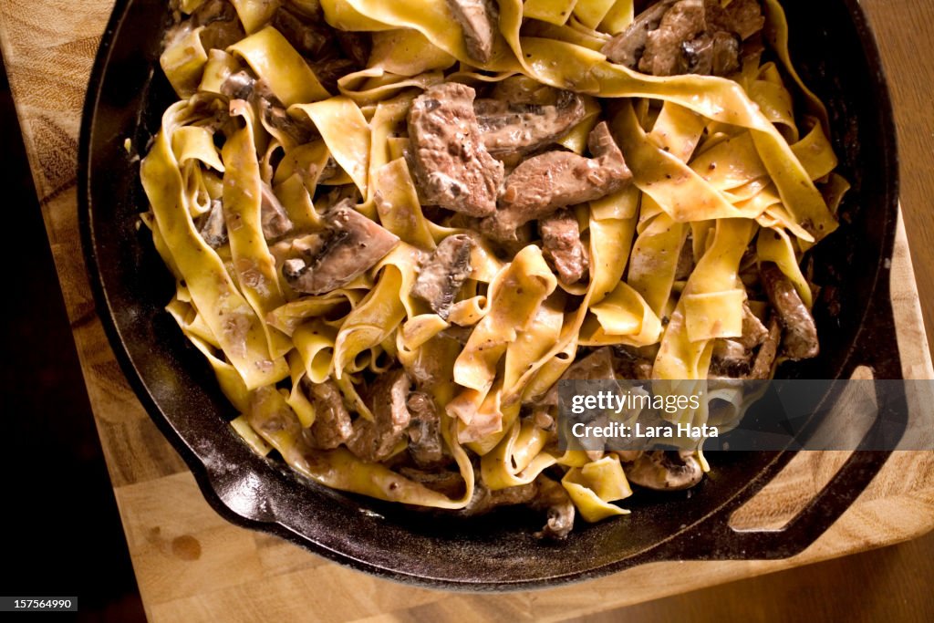 Beef stroganoff in a bowl on a wooden counter