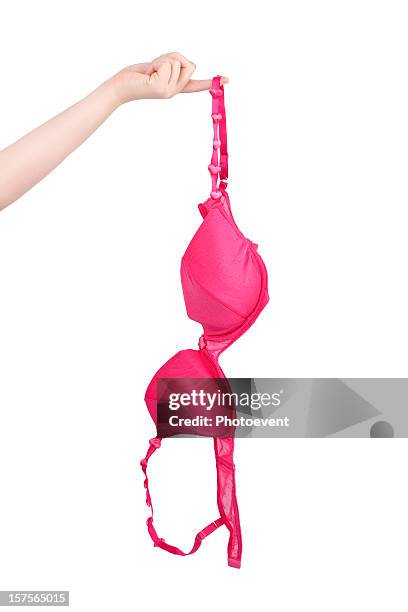 human hand holding pink bra - bra stock pictures, royalty-free photos & images