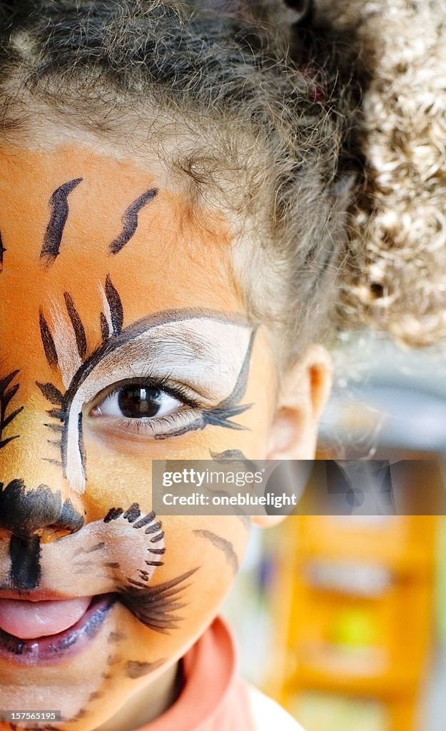 Happy Child with her tiger face paint.