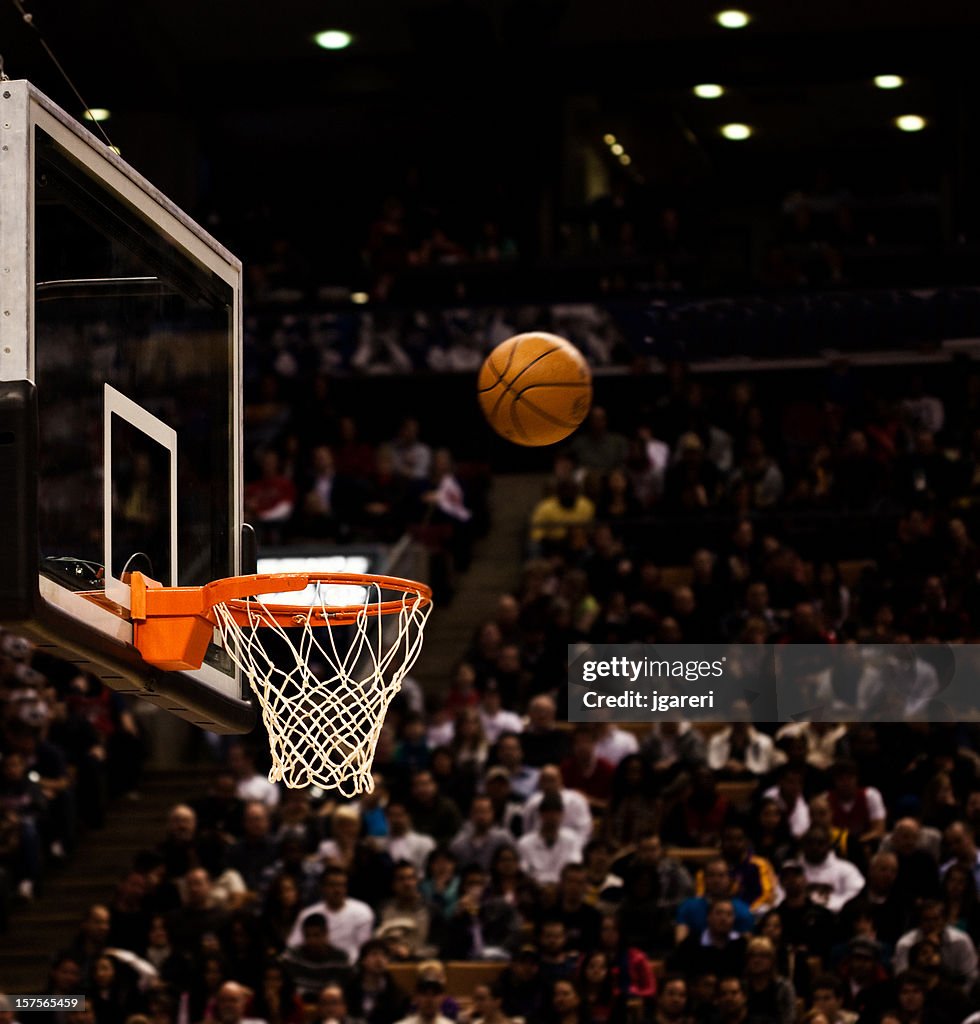Basketball net with basketball near hoop