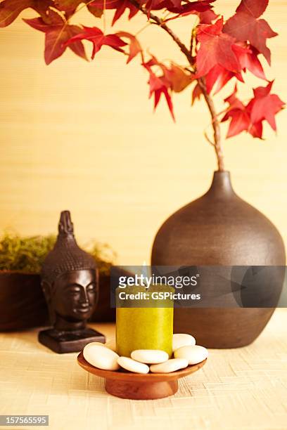 still life of red maple leaves in vase with buddha - feng shui house stock pictures, royalty-free photos & images