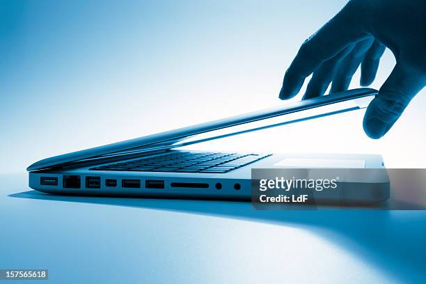 opening a laptop screen - closed laptop stock pictures, royalty-free photos & images