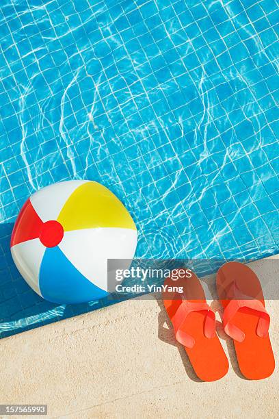 swimming pool summer fun with floating beach ball, flip flops - floating on water stock pictures, royalty-free photos & images