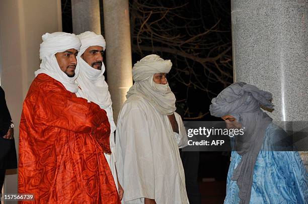 Members of the islamist Ansar Dine delegation, walk out after attending a mediation meeting with members of the Malian government and the Azawad...