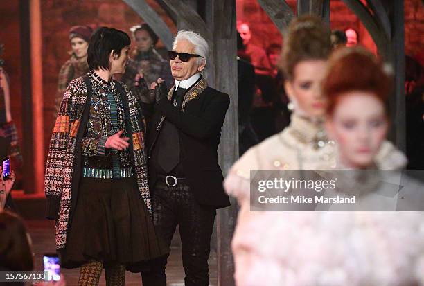 Karl Lagerfeld and Stella Tennant walk the runway at the CHANEL: Metiers d'Art fashion show at Linlithgow Palace on December 4, 2012 in Linlithgow,...