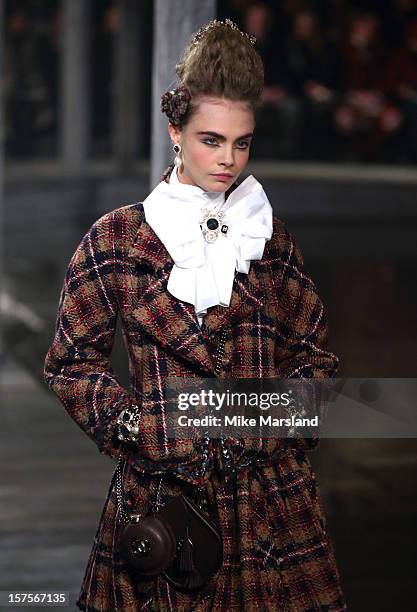 Cara Delevingne walks the runway at the CHANEL: Metiers d'Art fashion show at Linlithgow Palace on December 4, 2012 in Linlithgow, Scotland.