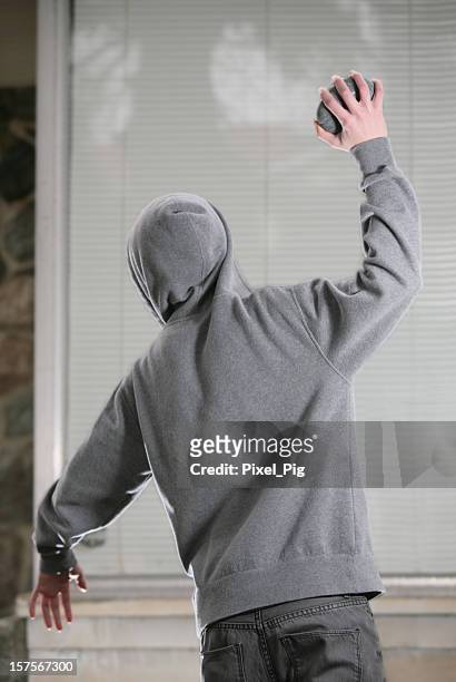 rock thrower and window ( mid-throw) - 4 - vandalism 個照片及圖片檔