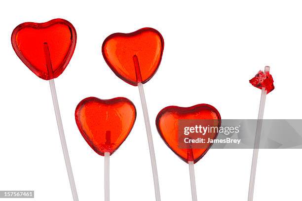 one broken heart; red heart-shaped lollipops, white background - lollipop background stock pictures, royalty-free photos & images