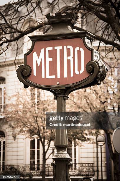 detail of metro sign, paris, france in desaturated colours. - paris metro sign stock pictures, royalty-free photos & images