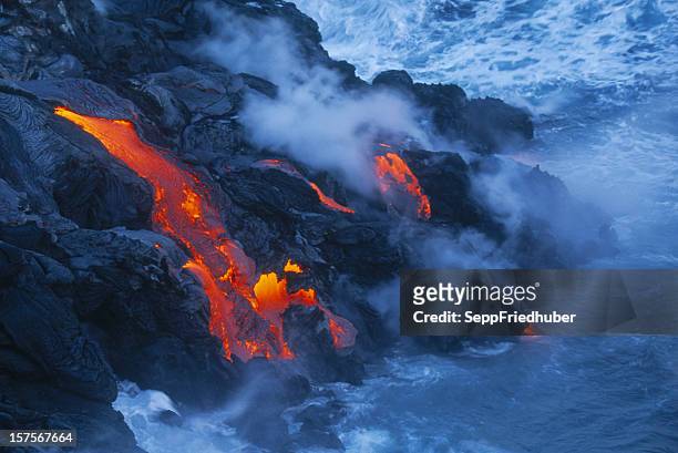 lava flow in hawaii flowing into the ocean - big island volcano national park stock pictures, royalty-free photos & images