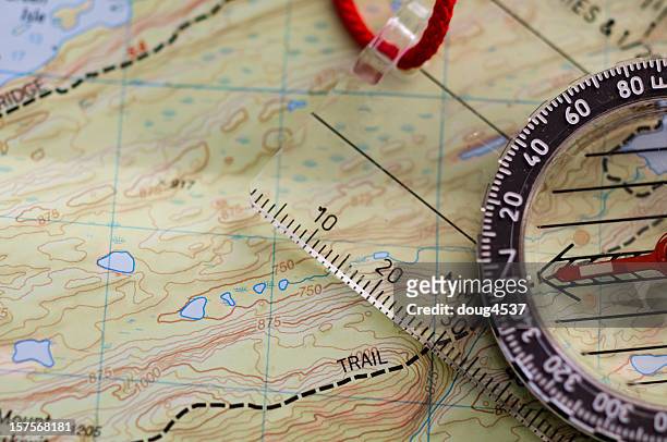 compass on map - hiking map stock pictures, royalty-free photos & images