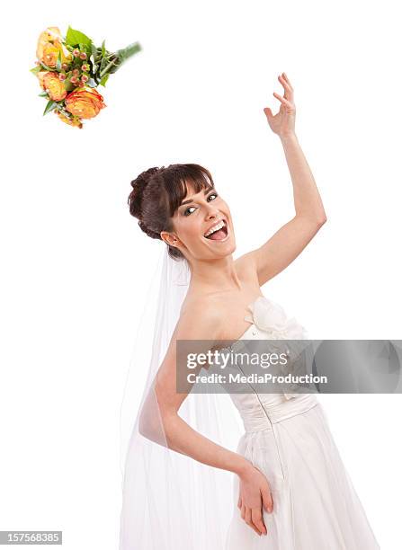 cheerful bride throwing her bouquet of flowers - bouquet toss stock pictures, royalty-free photos & images